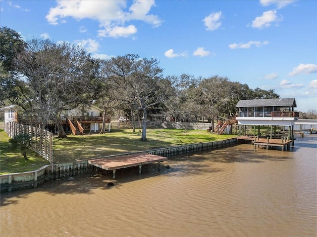 view of dock featuring a wooden deck, a yard, and stairway