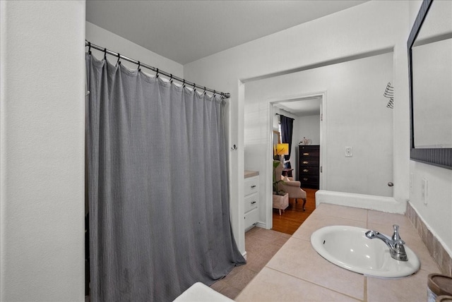 bathroom featuring a shower with shower curtain, tile patterned flooring, and vanity