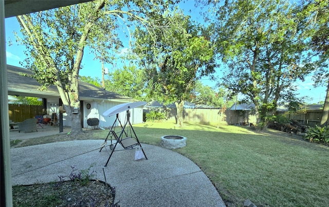 view of yard with a patio and an outdoor fire pit