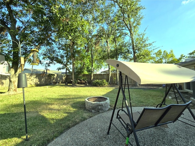 view of yard with a fire pit