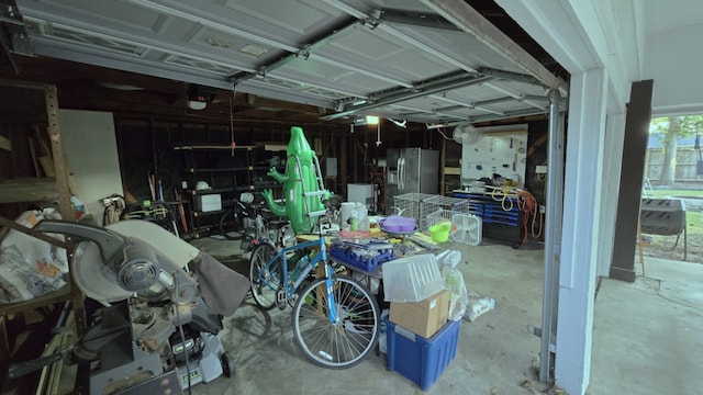 garage with stainless steel fridge with ice dispenser