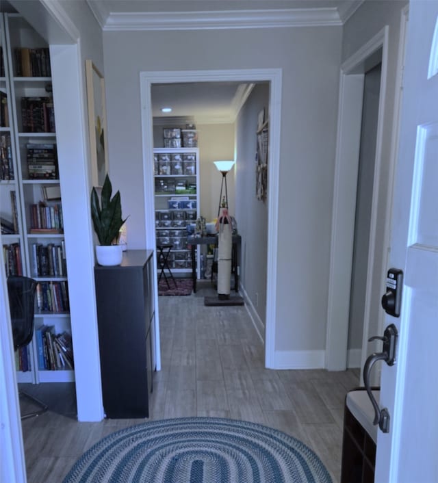 hallway with crown molding and hardwood / wood-style floors