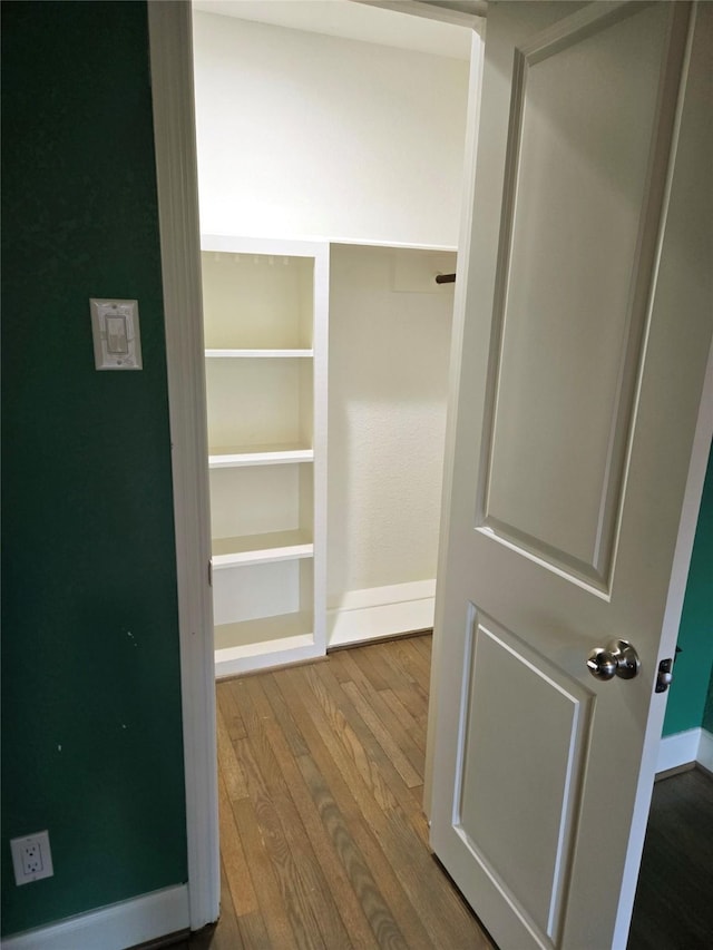 spacious closet featuring hardwood / wood-style flooring