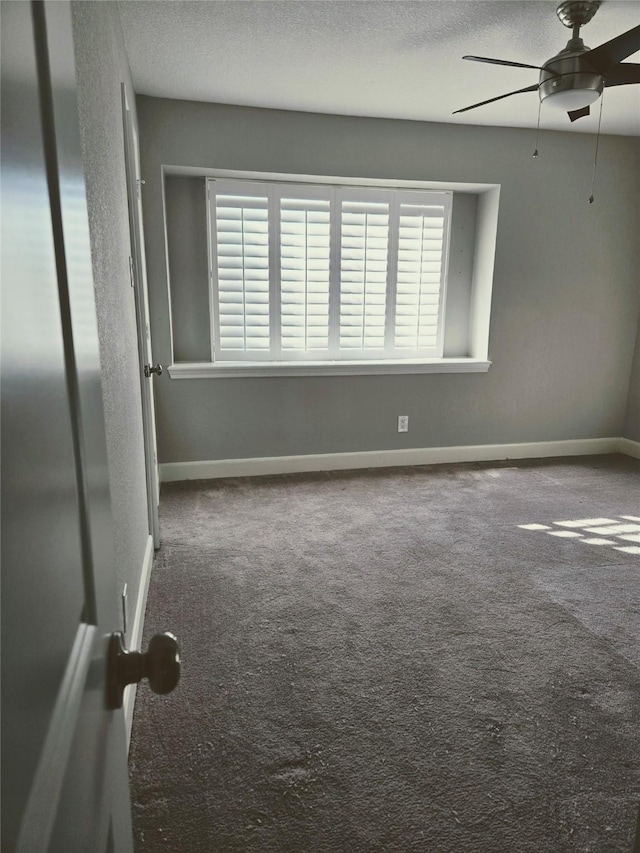 spare room featuring ceiling fan, plenty of natural light, carpet floors, and a textured ceiling