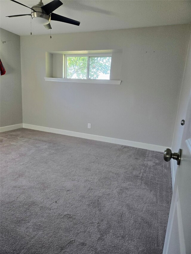 spare room with ceiling fan and carpet flooring