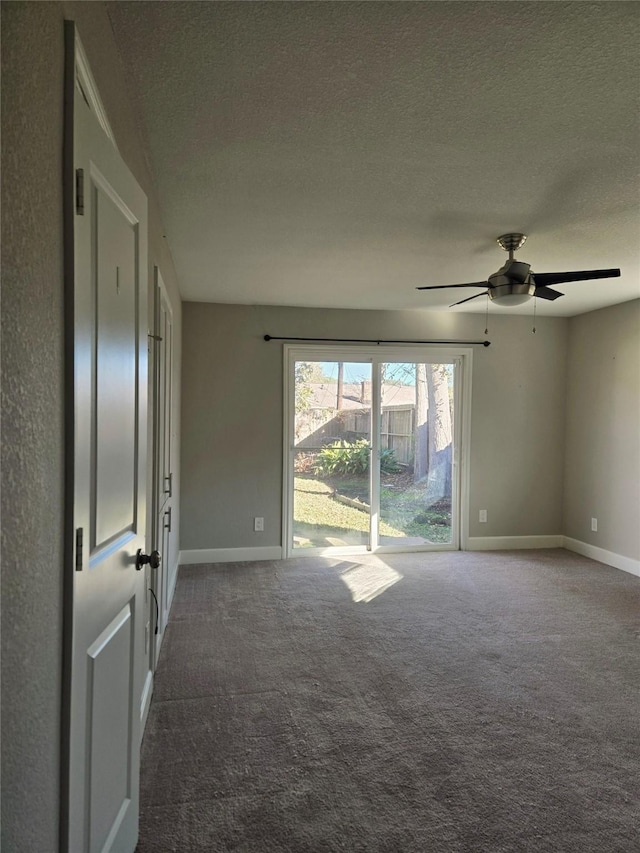 carpeted spare room with ceiling fan and a textured ceiling