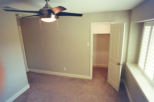 unfurnished bedroom with carpet floors, baseboards, and a ceiling fan