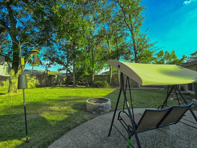 view of yard featuring a patio area, an outdoor fire pit, and a fenced backyard