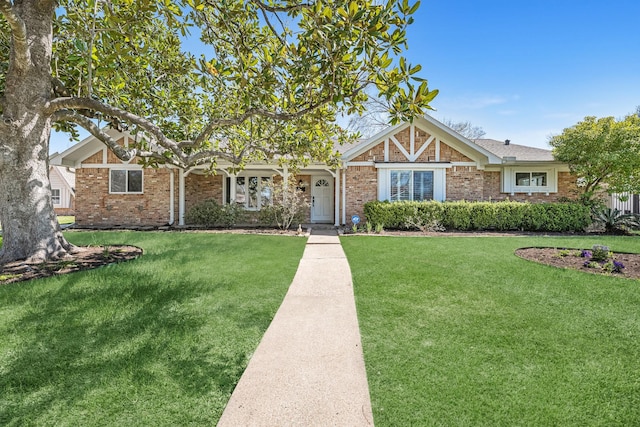 view of front of home with a front lawn and brick siding