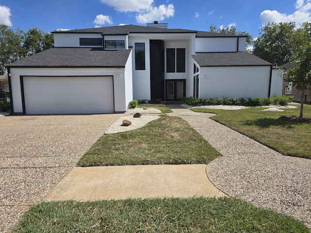 view of front of house with a garage and a front yard