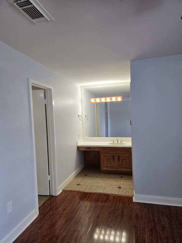 bathroom featuring wood-type flooring and vanity