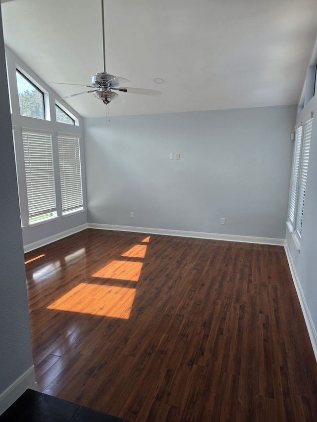 unfurnished room with vaulted ceiling, dark hardwood / wood-style flooring, and ceiling fan