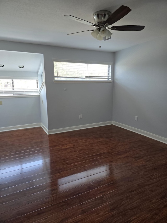 spare room featuring ceiling fan and dark hardwood / wood-style flooring