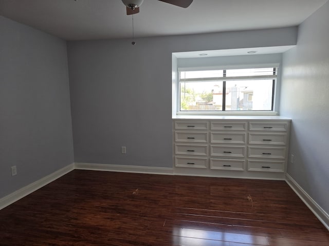 unfurnished bedroom featuring ceiling fan and dark wood-type flooring