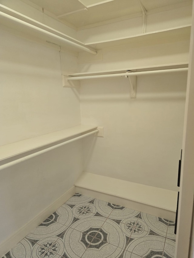 spacious closet with tile patterned floors