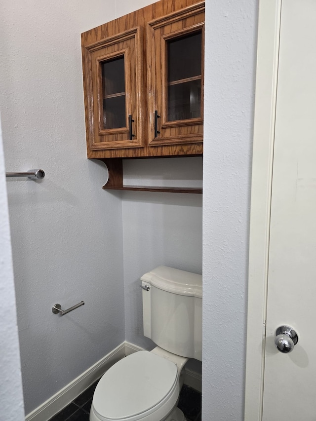 bathroom featuring tile patterned floors and toilet