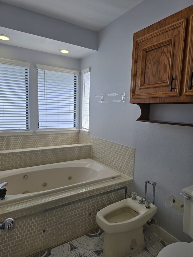 bathroom with a bidet, a relaxing tiled tub, and toilet