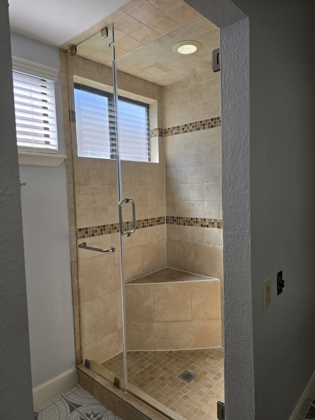 bathroom with a shower with shower door