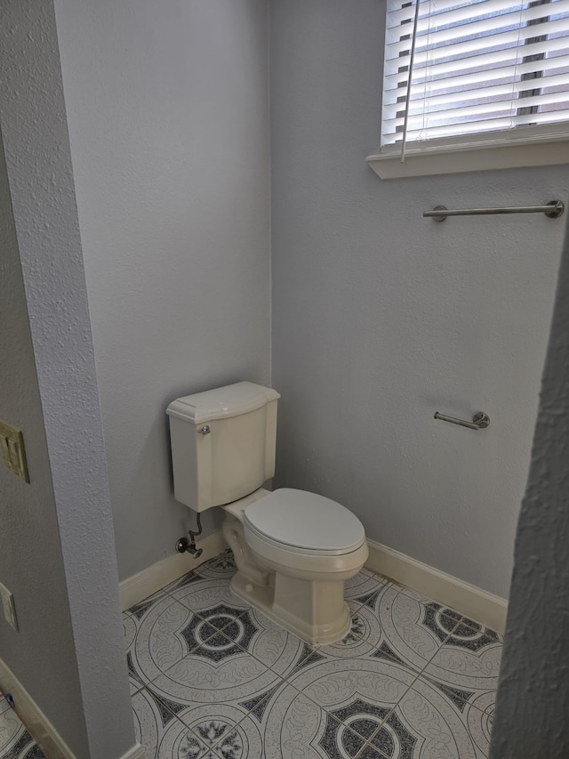 bathroom featuring toilet and tile patterned floors