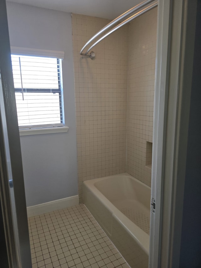 bathroom with tiled shower / bath and tile patterned floors