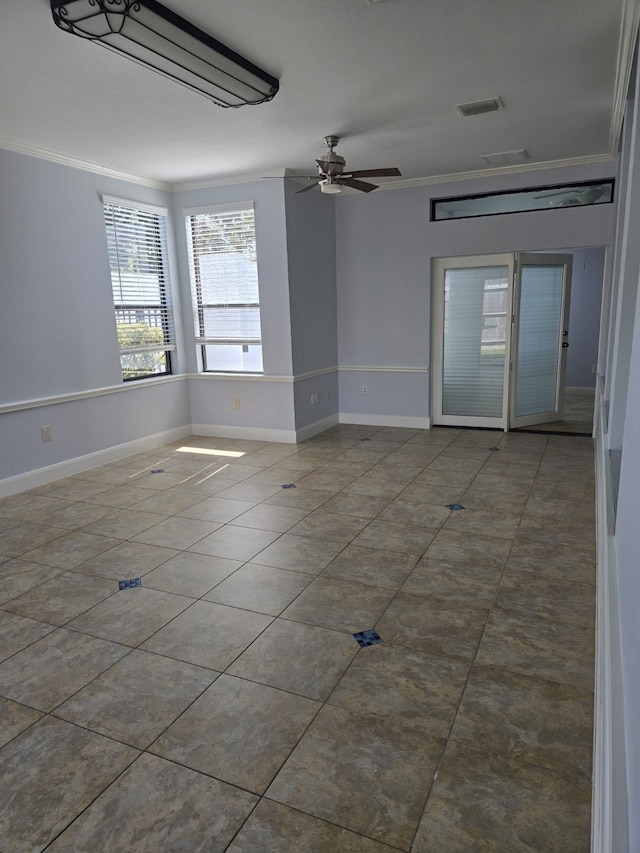 spare room with ceiling fan, ornamental molding, and tile patterned floors