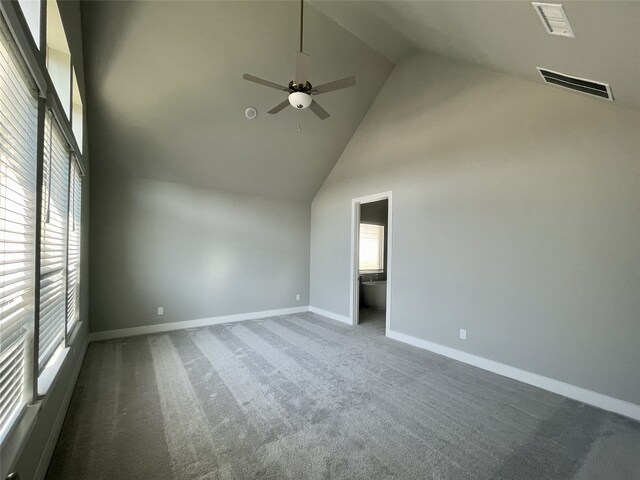 unfurnished room with ceiling fan, plenty of natural light, and high vaulted ceiling