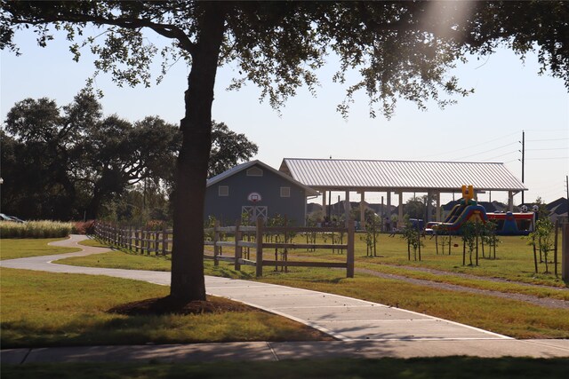 surrounding community featuring a playground and a lawn