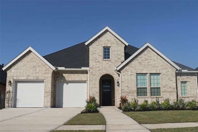 view of front of home featuring a front yard and a garage