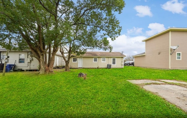 rear view of house with a lawn