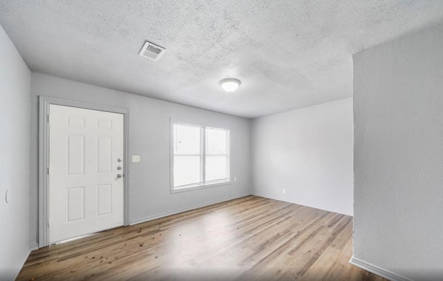 7019 Anderson St, Texas City, TX 77591 - foyer entrance with a textured ceiling and light hardwood / wood-style floors