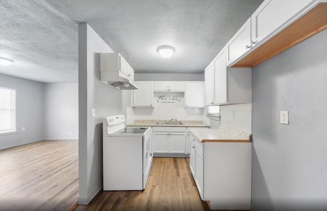 7019 Anderson St, Texas City, TX 77591 - kitchen featuring white electric range oven, sink, wood-type flooring, a textured ceiling, and white cabinetry