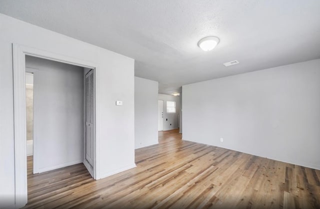 7019 Anderson St, Texas City, TX 77591 - spare room with a textured ceiling and light hardwood / wood-style floors