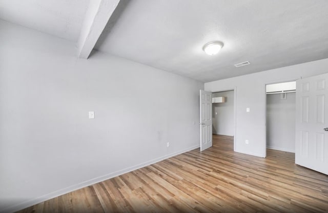 7019 Anderson St, Texas City, TX 77591 - unfurnished bedroom featuring beamed ceiling and light hardwood / wood-style flooring