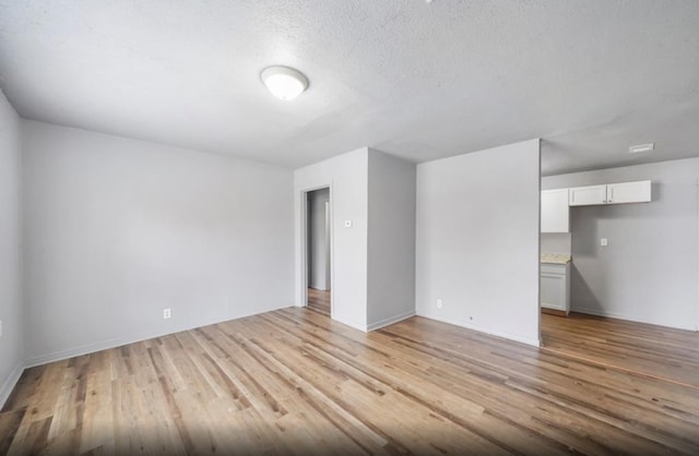7019 Anderson St, Texas City, TX 77591 - spare room with a textured ceiling and light hardwood / wood-style floors