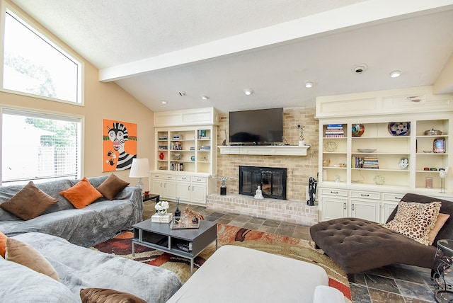 living room featuring vaulted ceiling with beams and a brick fireplace