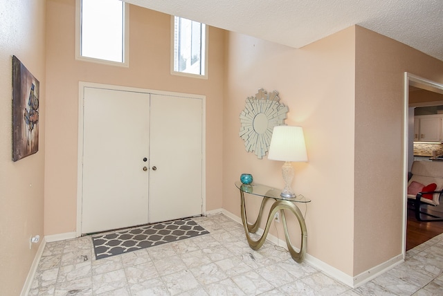 entrance foyer with a textured ceiling