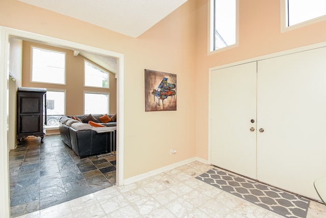 foyer with high vaulted ceiling