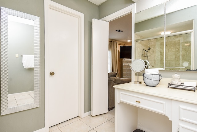 bathroom with vanity, a shower with door, and tile patterned floors