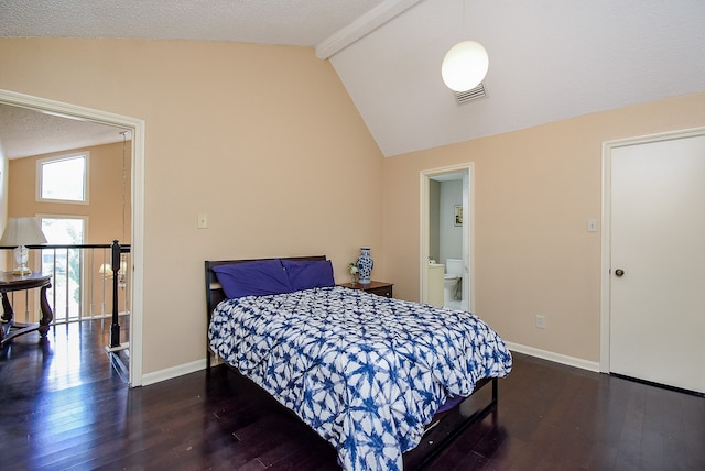 bedroom featuring vaulted ceiling with beams, a textured ceiling, connected bathroom, and dark hardwood / wood-style flooring