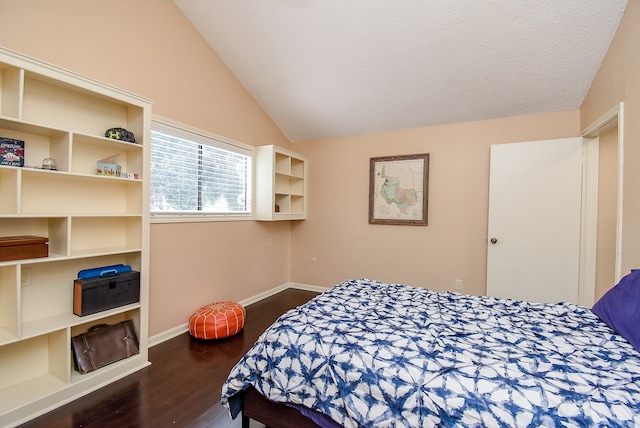 bedroom featuring a textured ceiling, lofted ceiling, and dark hardwood / wood-style flooring