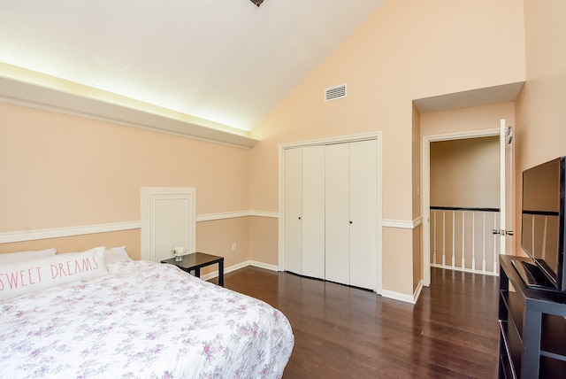 bedroom featuring high vaulted ceiling, a closet, and dark hardwood / wood-style flooring