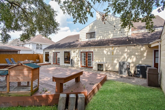 back of property featuring a lawn, cooling unit, a deck, and french doors