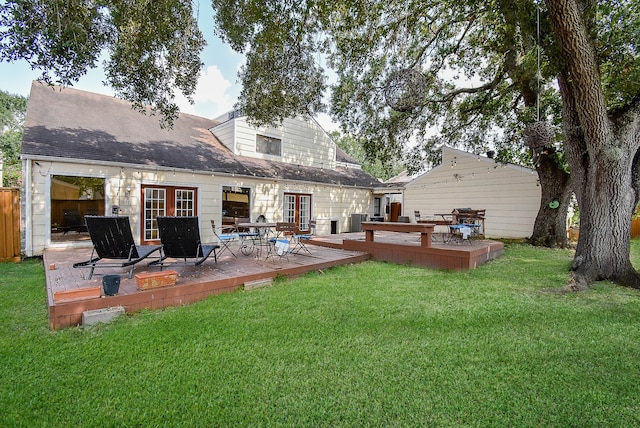 back of house featuring a deck and a lawn