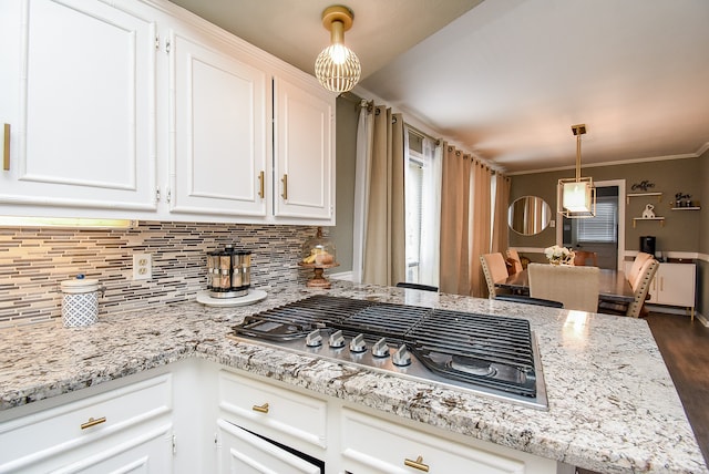 kitchen featuring hanging light fixtures, stainless steel gas cooktop, backsplash, dark wood-type flooring, and white cabinetry