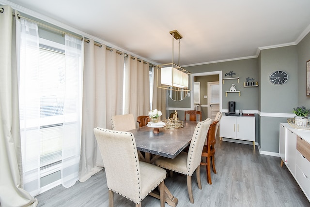 dining room featuring wood-type flooring and crown molding