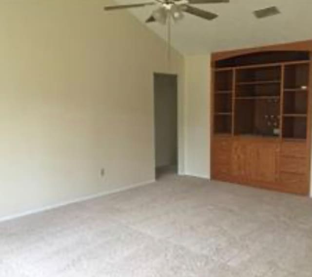 unfurnished room with ceiling fan and light colored carpet