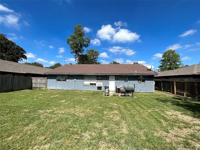 rear view of property featuring a yard