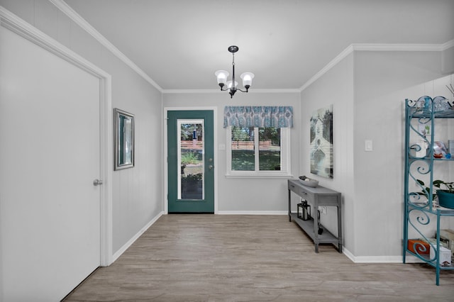 foyer entrance featuring crown molding, light hardwood / wood-style floors, and a chandelier