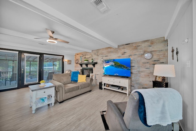 living room with light wood-type flooring, wooden walls, ceiling fan, and beamed ceiling