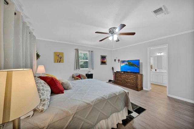 bedroom with ceiling fan, hardwood / wood-style flooring, ensuite bathroom, and ornamental molding